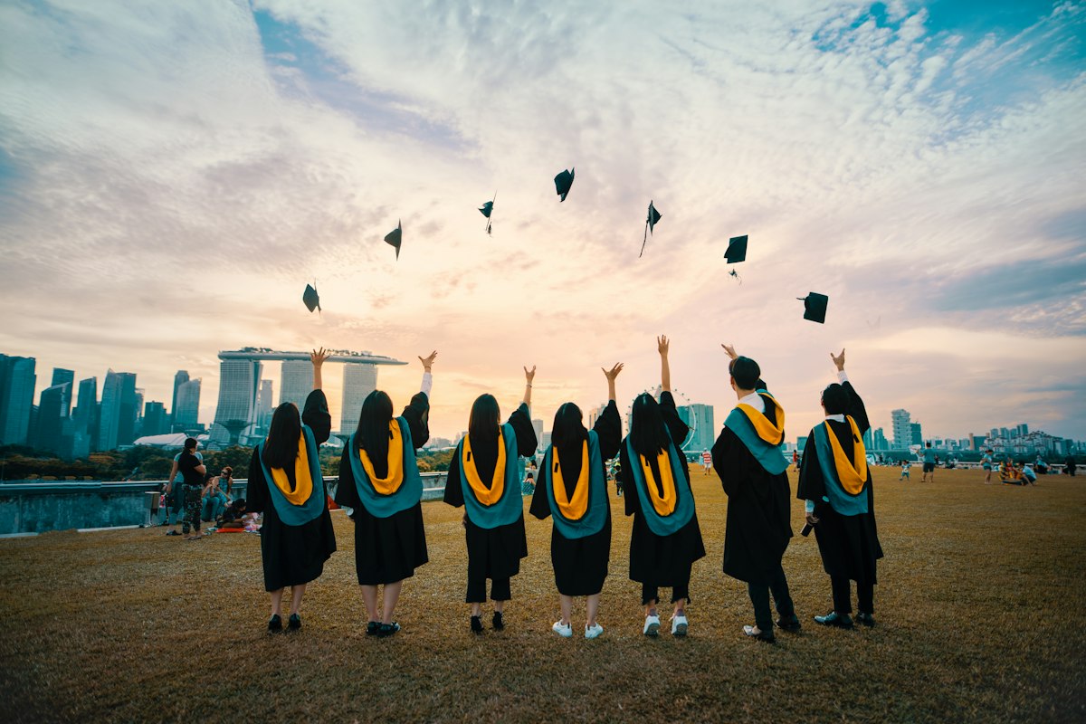 Graduating university students celebrating — complete guide to university admissions in Pakistan